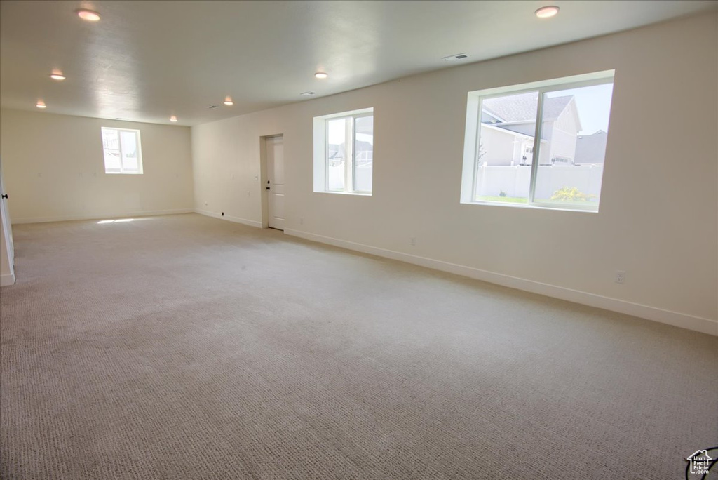 Empty room featuring recessed lighting and light colored carpet