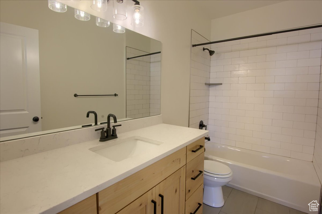 Full bath featuring vanity, bathing tub / shower combination, and tile patterned flooring