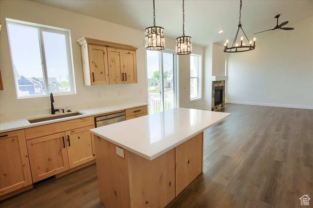 Kitchen with a chandelier, light brown cabinetry, and plenty of natural light