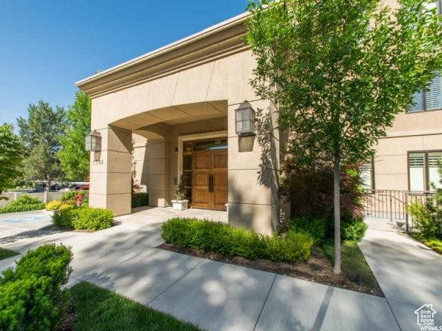 Entrance to property featuring stucco siding