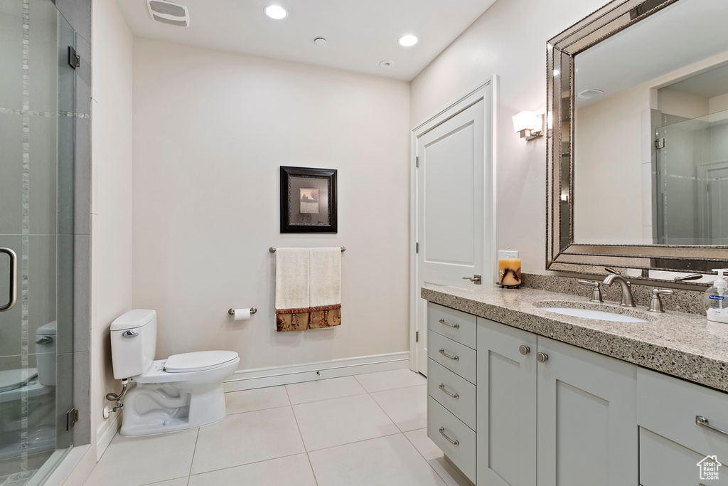 Bathroom with vanity, tile patterned flooring, a shower stall, and recessed lighting