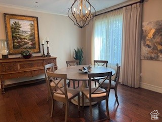 Dining room featuring a chandelier, ornamental molding, and wood finished floors