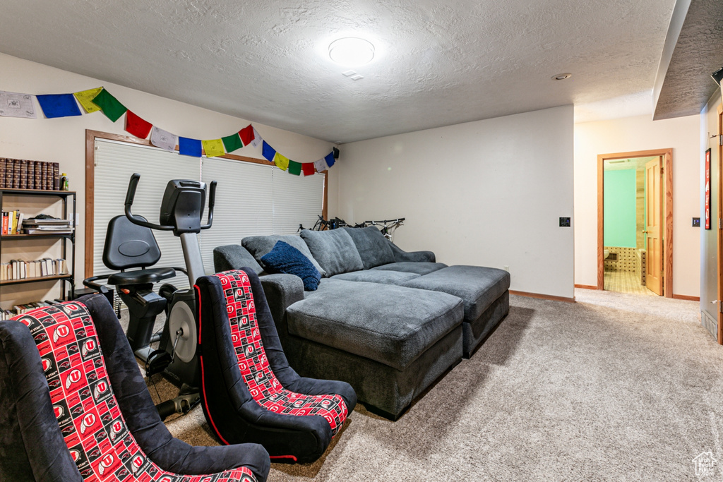 Carpeted bedroom featuring a textured ceiling and baseboards