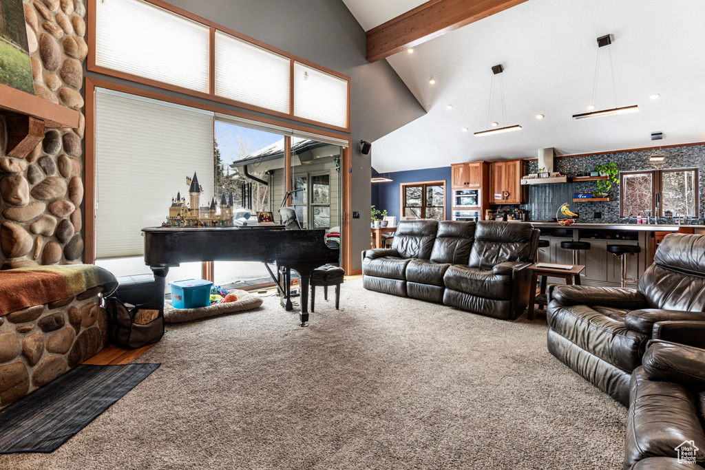 Living room featuring carpet flooring, high vaulted ceiling, beamed ceiling, bar area, and healthy amount of natural light