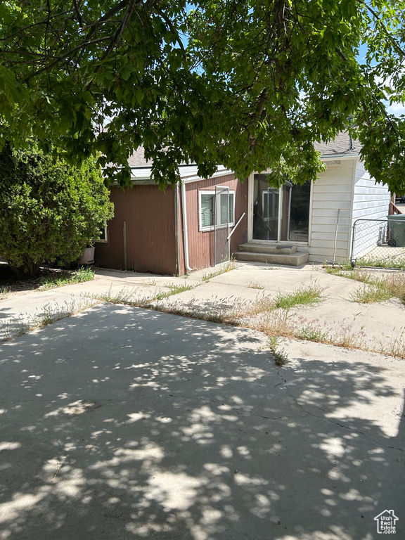 View of front of house with entry steps and roof with shingles