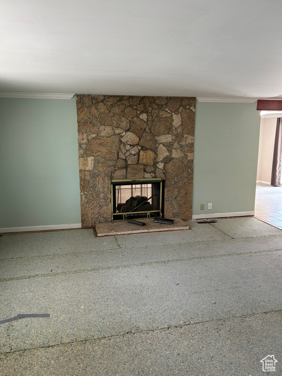 Detailed view of crown molding and a stone fireplace
