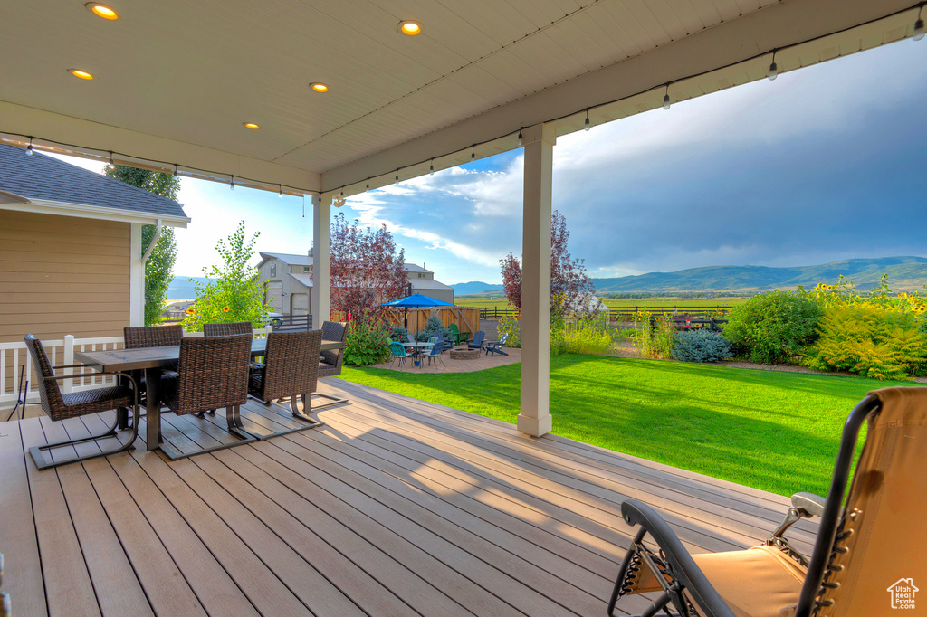 Deck featuring outdoor dining area and a mountain view