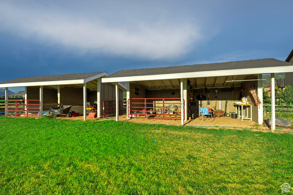 Back of property with an exterior structure and an outdoor structure