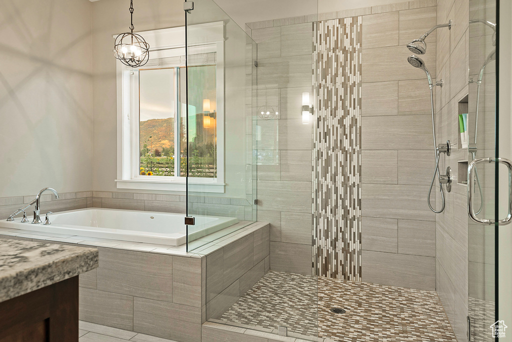 Bathroom with a shower stall and a bath