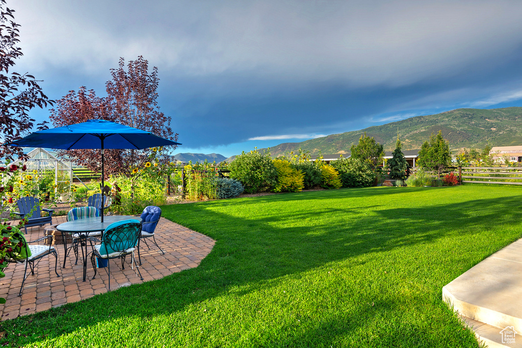 View of yard with a mountain view and a patio