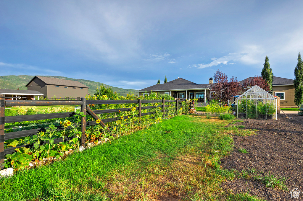 View of yard featuring an exterior structure, an outdoor structure, and a mountain view