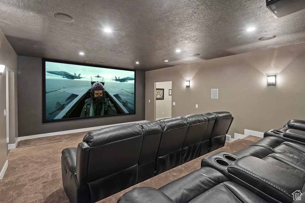 Home theater room featuring carpet flooring, recessed lighting, baseboards, and a textured ceiling