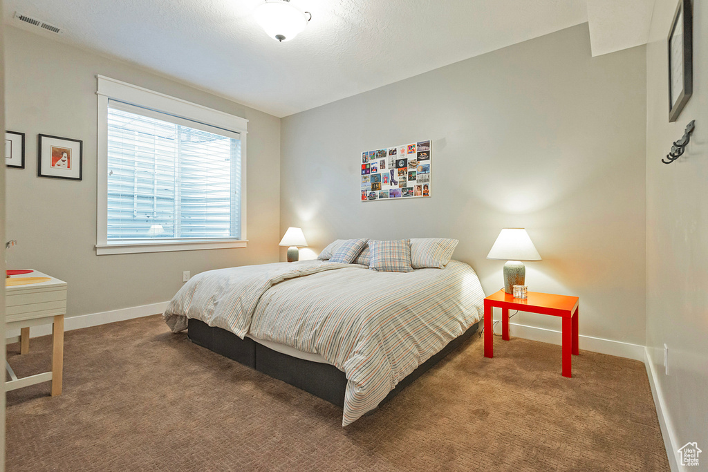 Carpeted bedroom featuring baseboards
