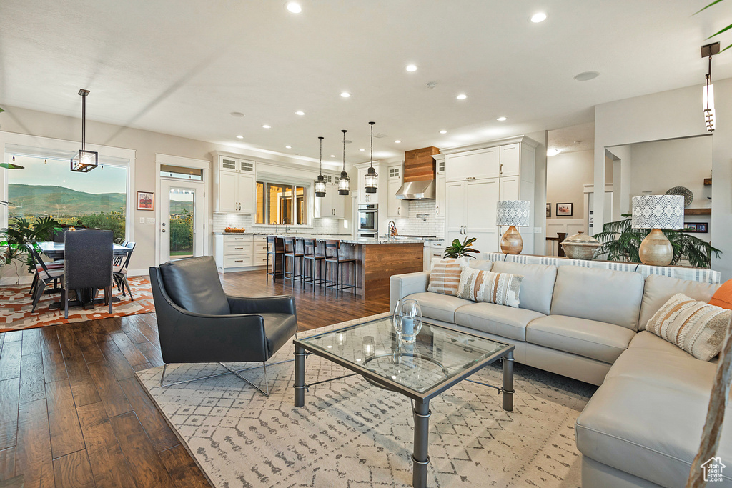 Living area with recessed lighting and dark wood finished floors