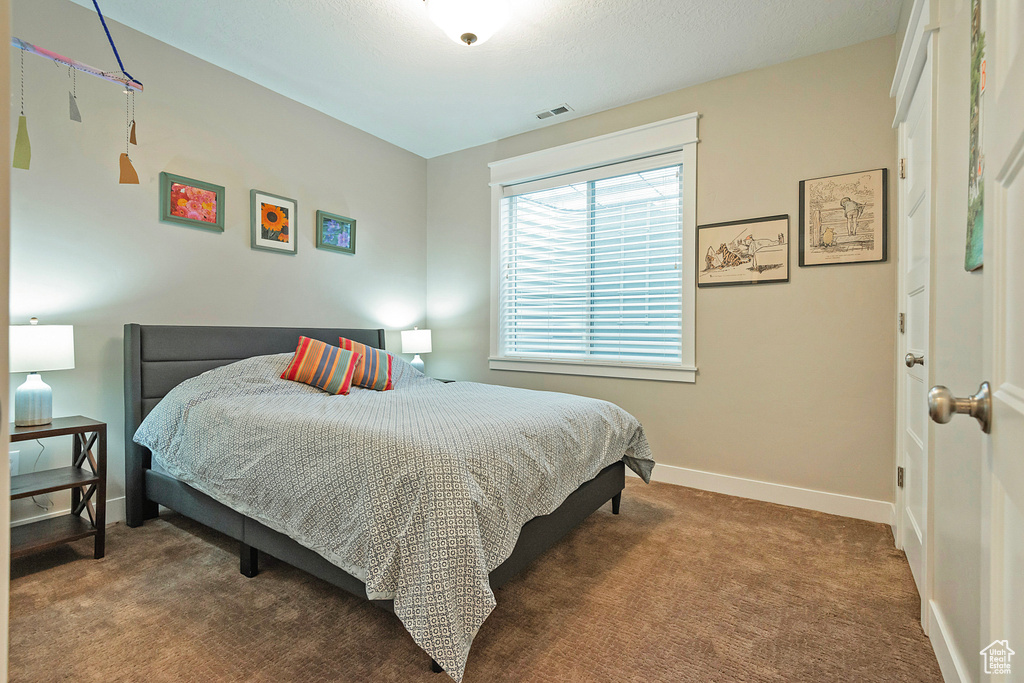 Carpeted bedroom featuring baseboards