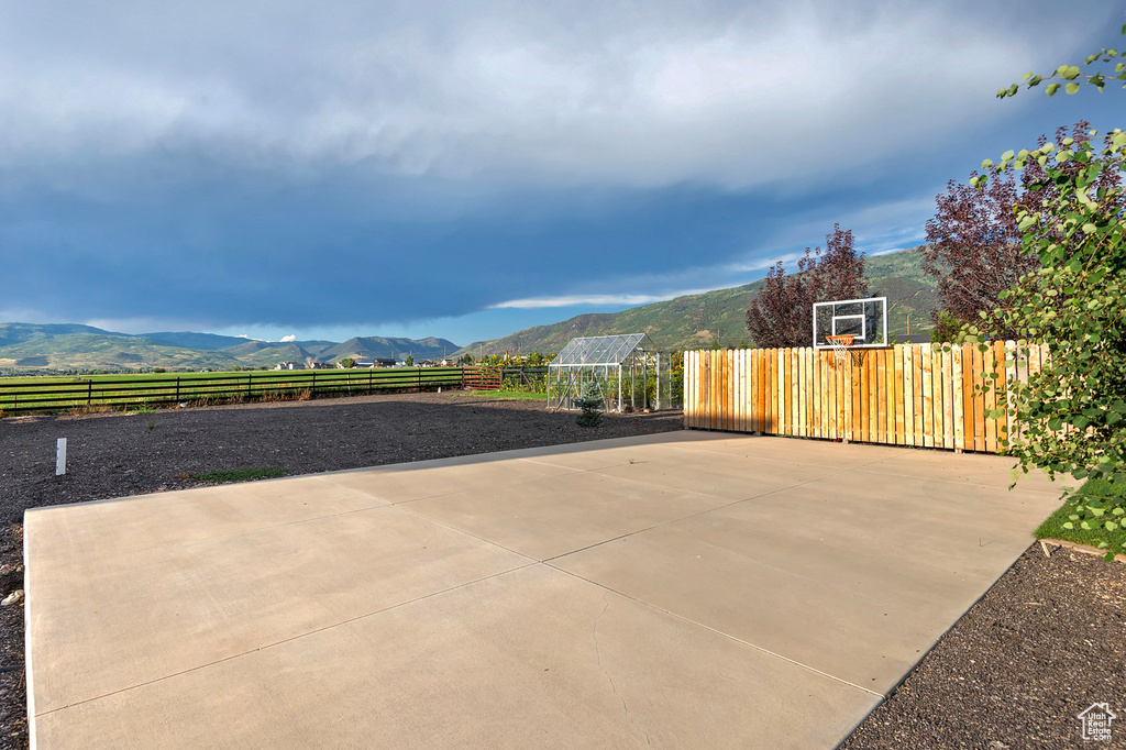 View of patio featuring community basketball court and a mountain view