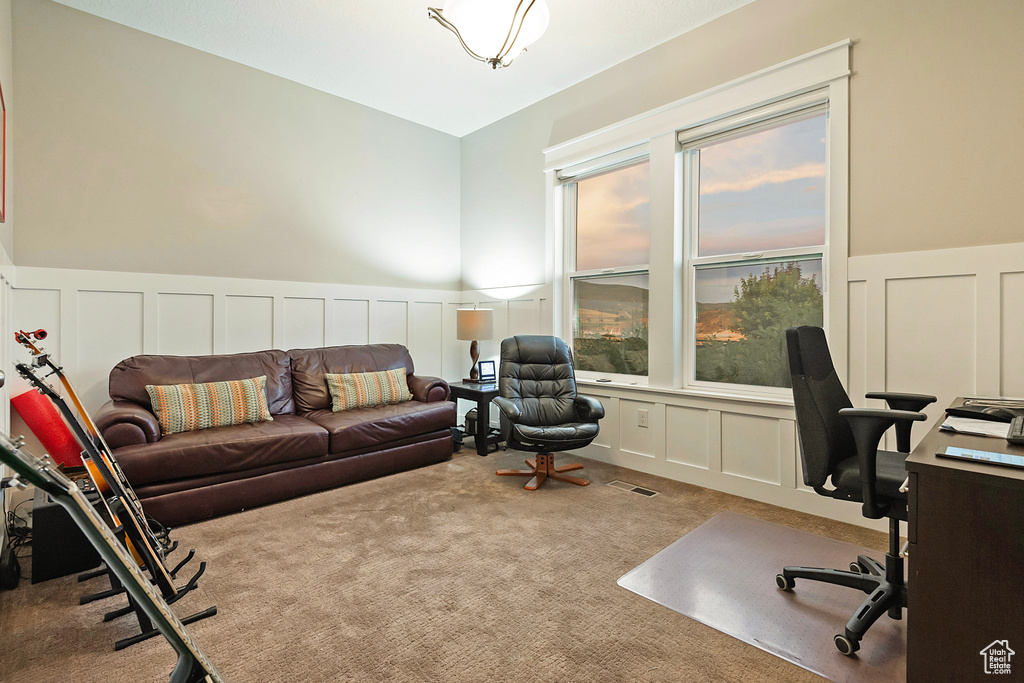 Office space featuring a decorative wall, a wainscoted wall, and carpet floors