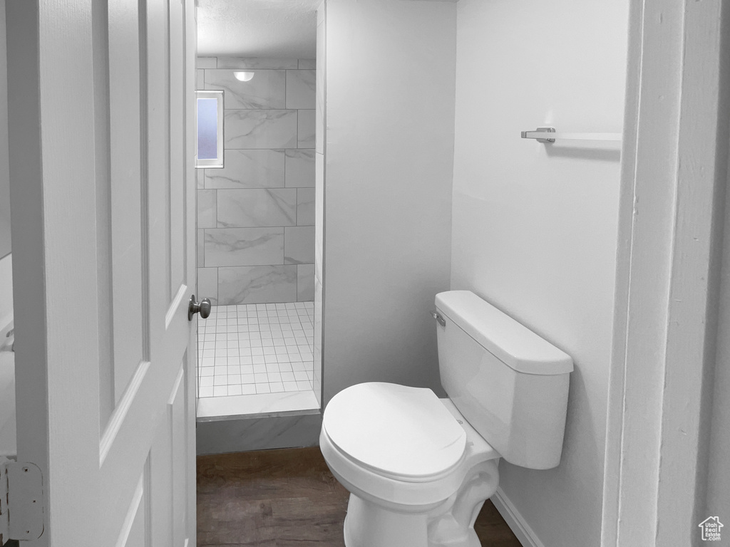 Bathroom featuring a stall shower and wood finished floors
