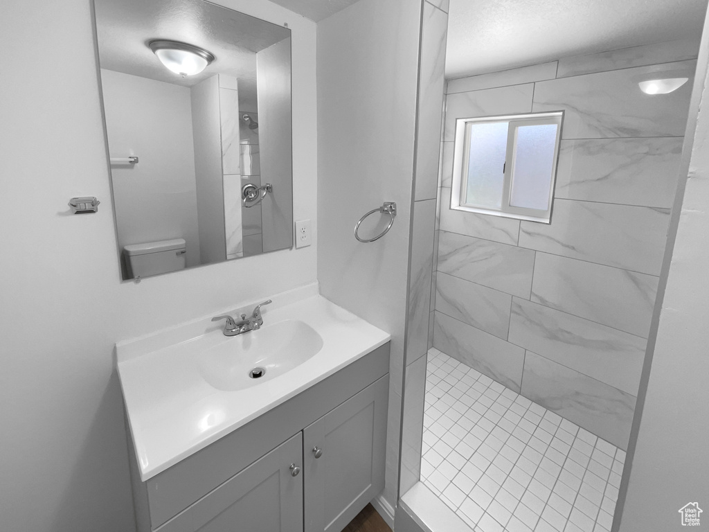Full bathroom featuring vanity and tiled shower