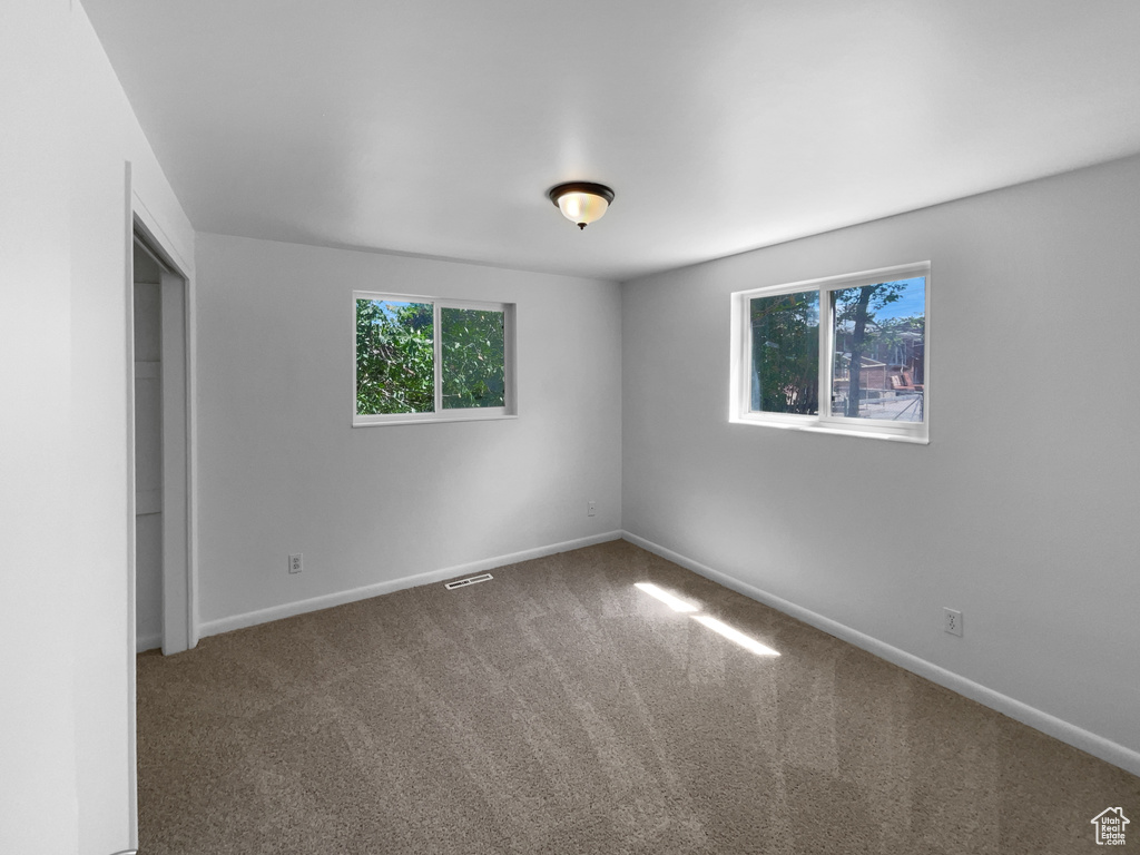 Unfurnished bedroom with carpet and baseboards