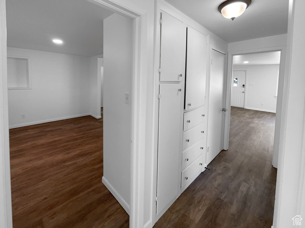 Hall featuring dark wood finished floors and recessed lighting