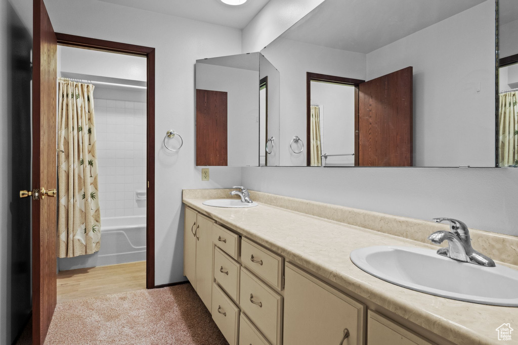 Full bath with double vanity and shower / bath combo