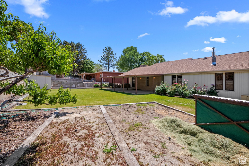 Back of house featuring a patio and a shingled roof