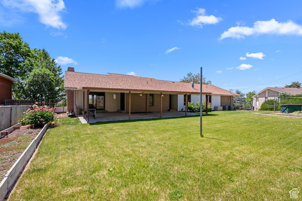 Rear view of property with a patio
