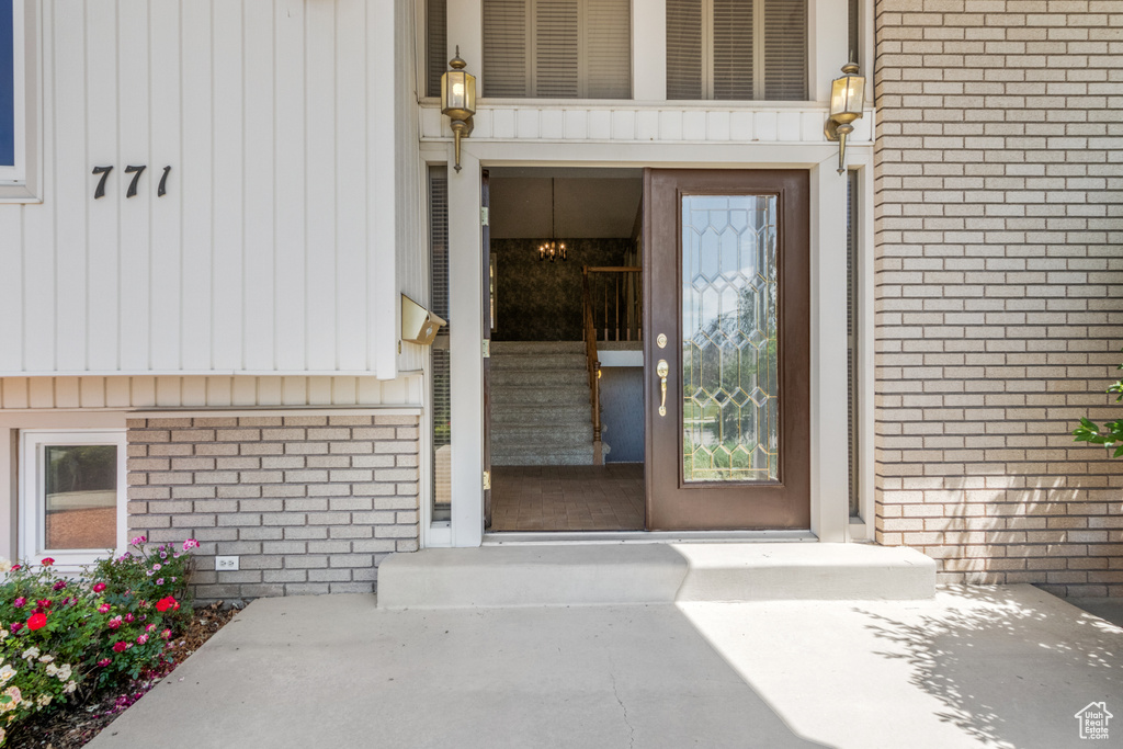 Doorway to property featuring brick siding