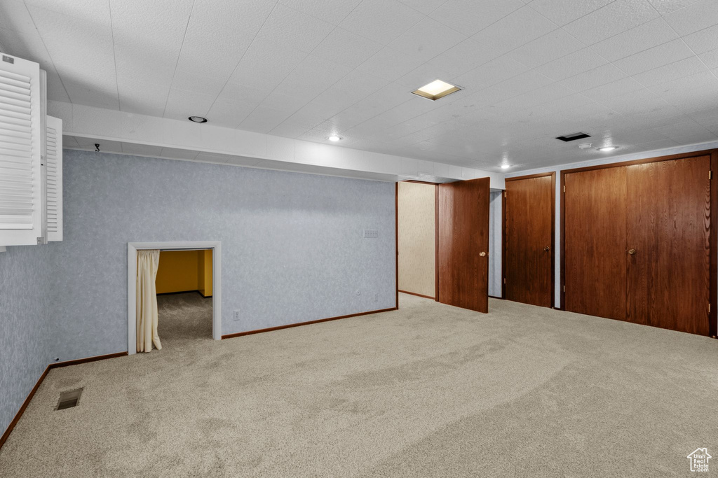 Finished below grade area featuring carpet flooring and recessed lighting