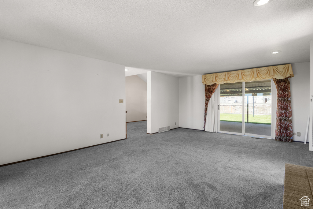 Unfurnished room featuring carpet flooring, recessed lighting, and a textured ceiling
