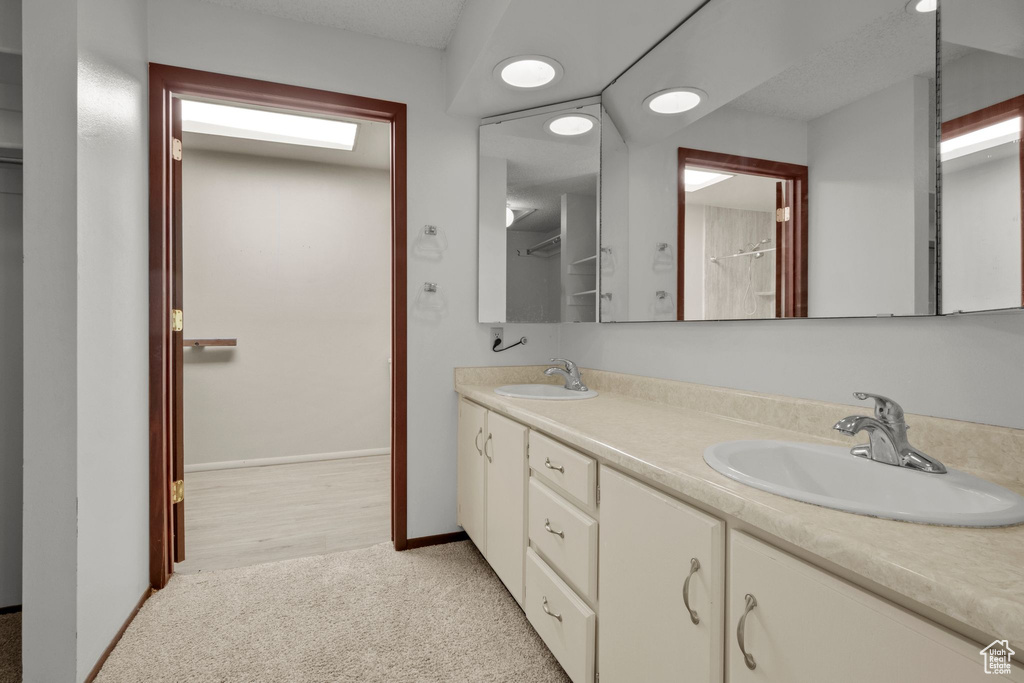 Bathroom with double vanity and baseboards