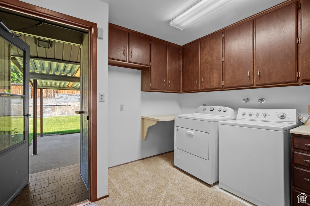 Laundry area featuring cabinet space and washer and dryer
