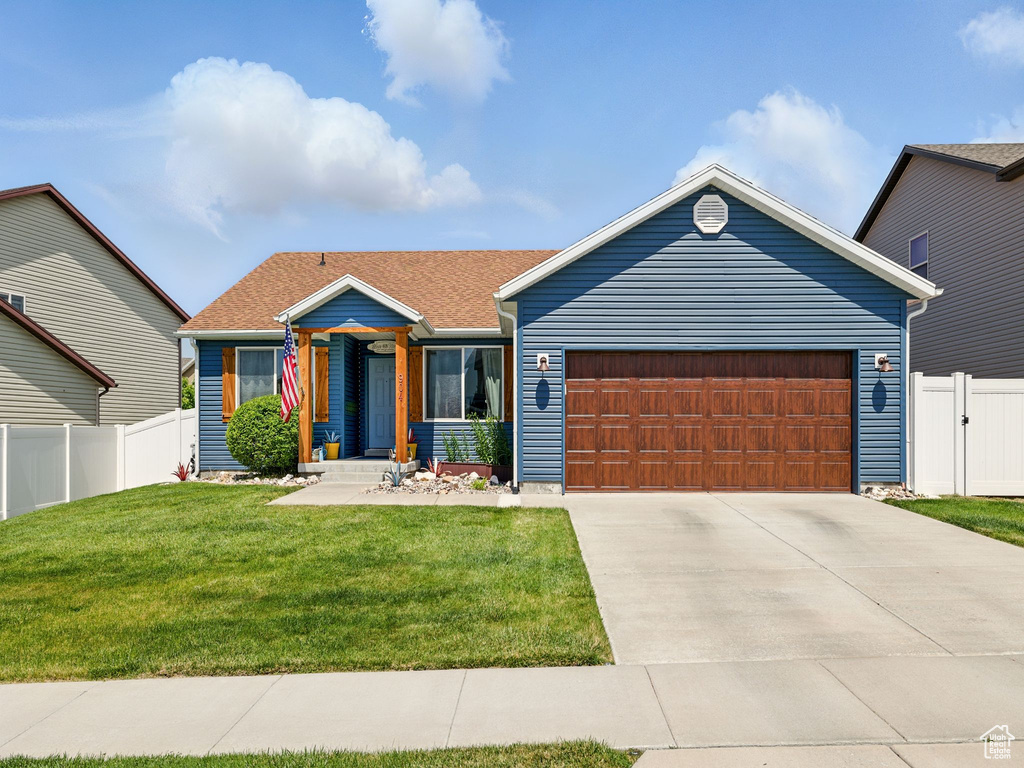 View of front of home with a garage and driveway