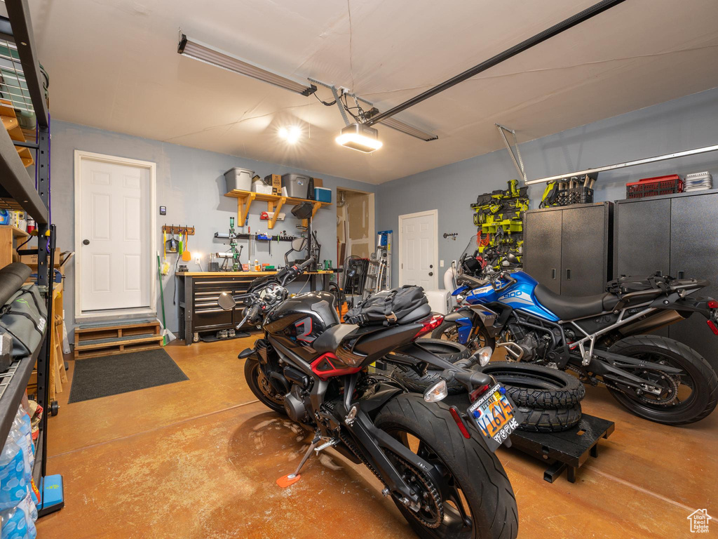 Garage with a garage door opener and a workshop area