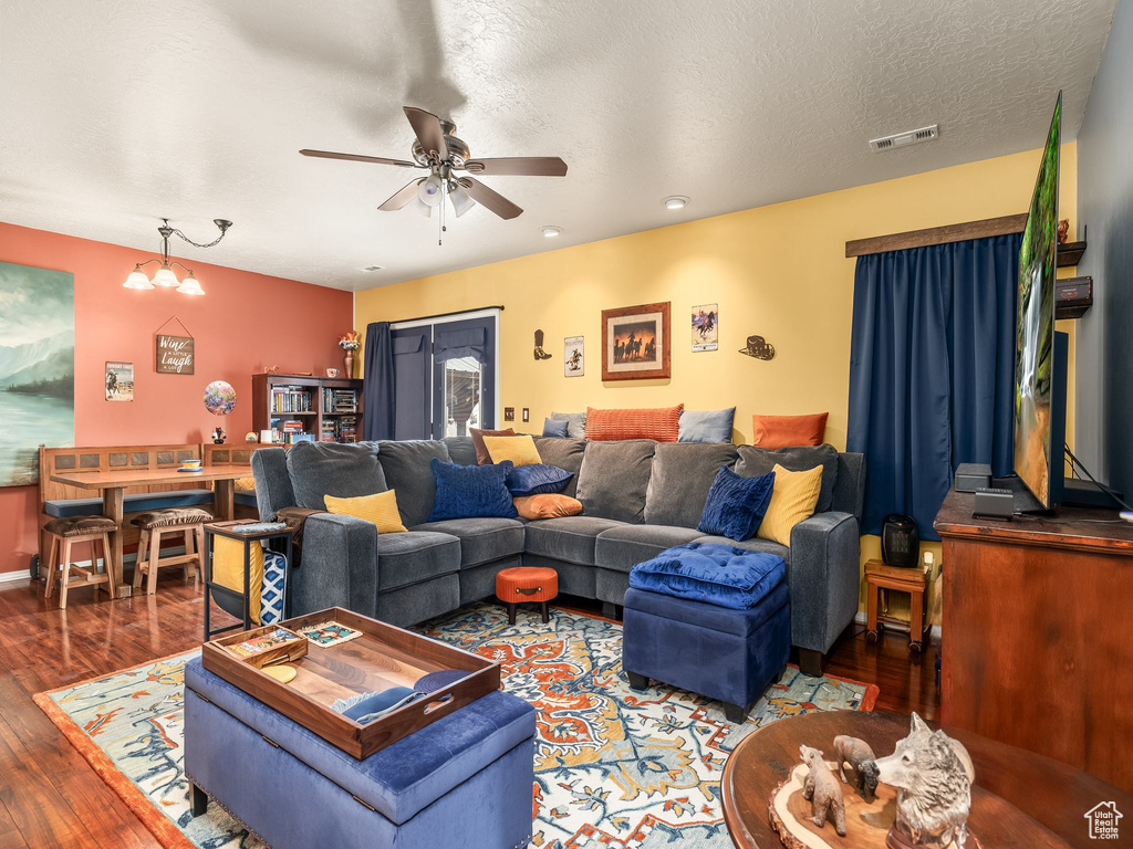 Living room featuring ceiling fan and wood finished floors