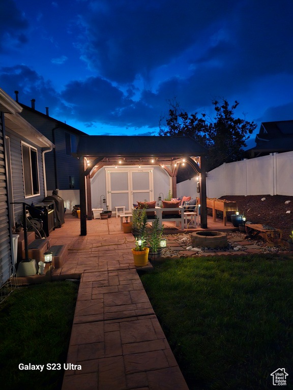 Fenced backyard with a patio and an outdoor hangout area