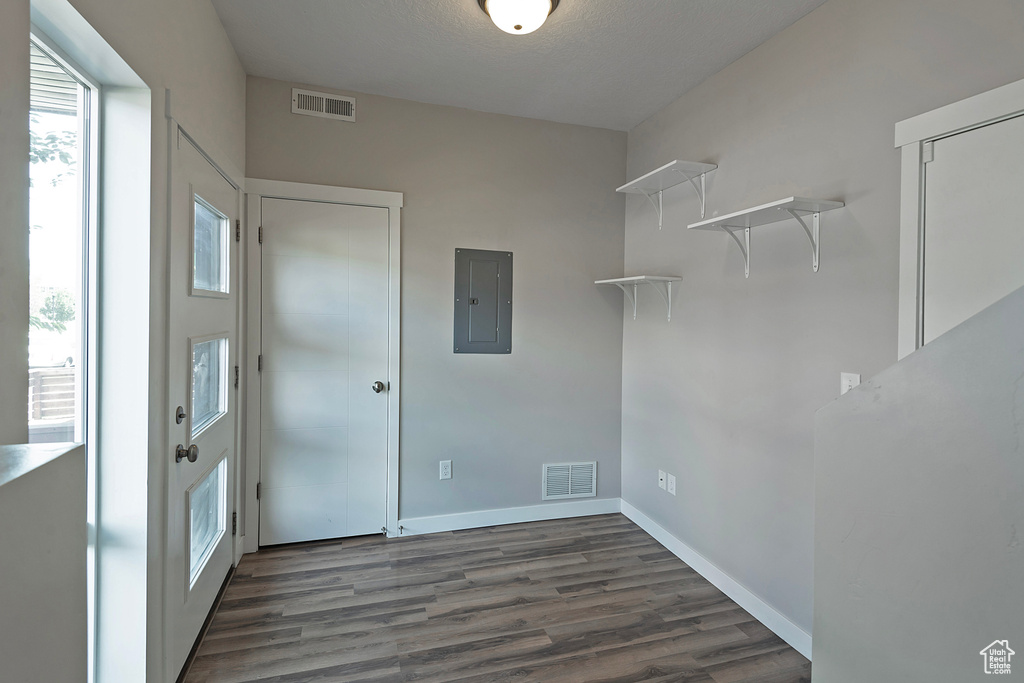 Washroom featuring electric panel and wood finished floors