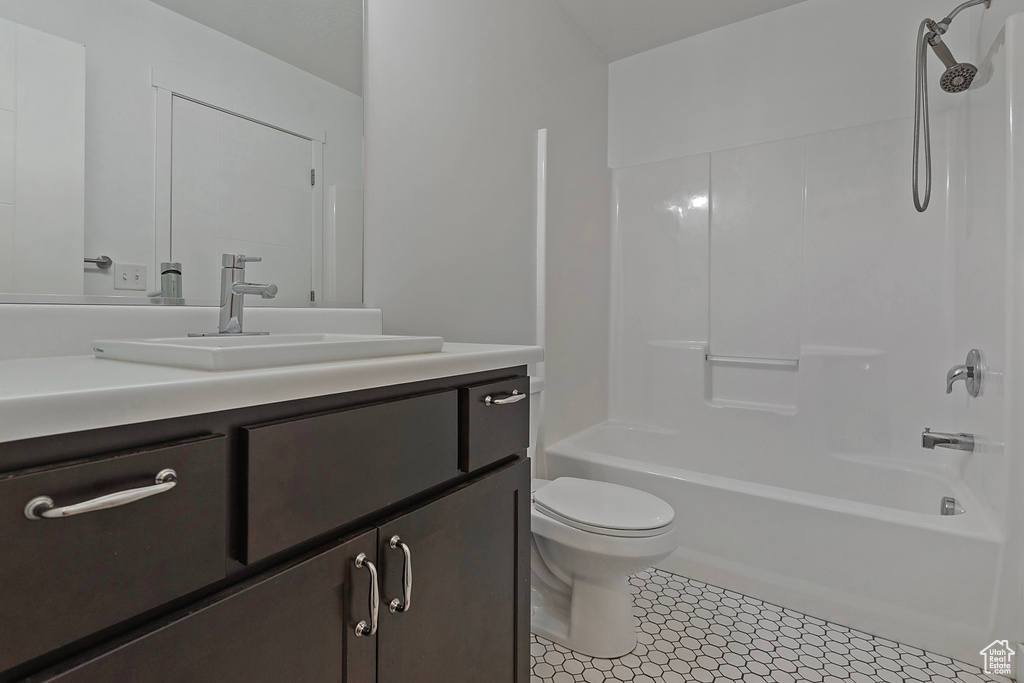 Bathroom featuring vanity,  shower combination, and tile patterned flooring