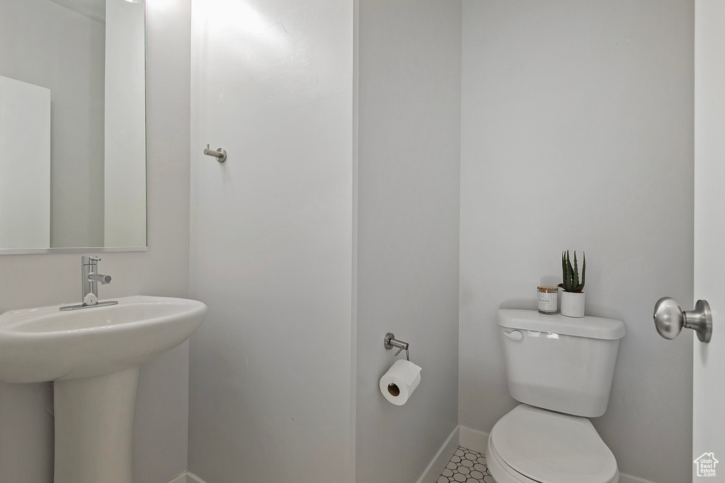 Half bath with toilet and baseboards