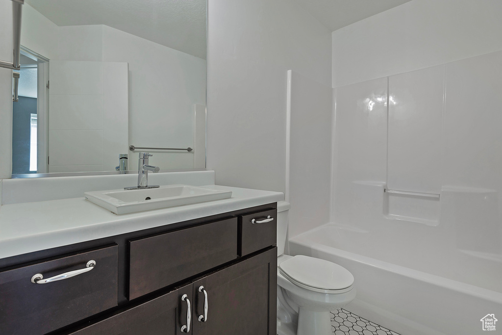Full bath featuring vanity, bathing tub / shower combination, and tile patterned floors