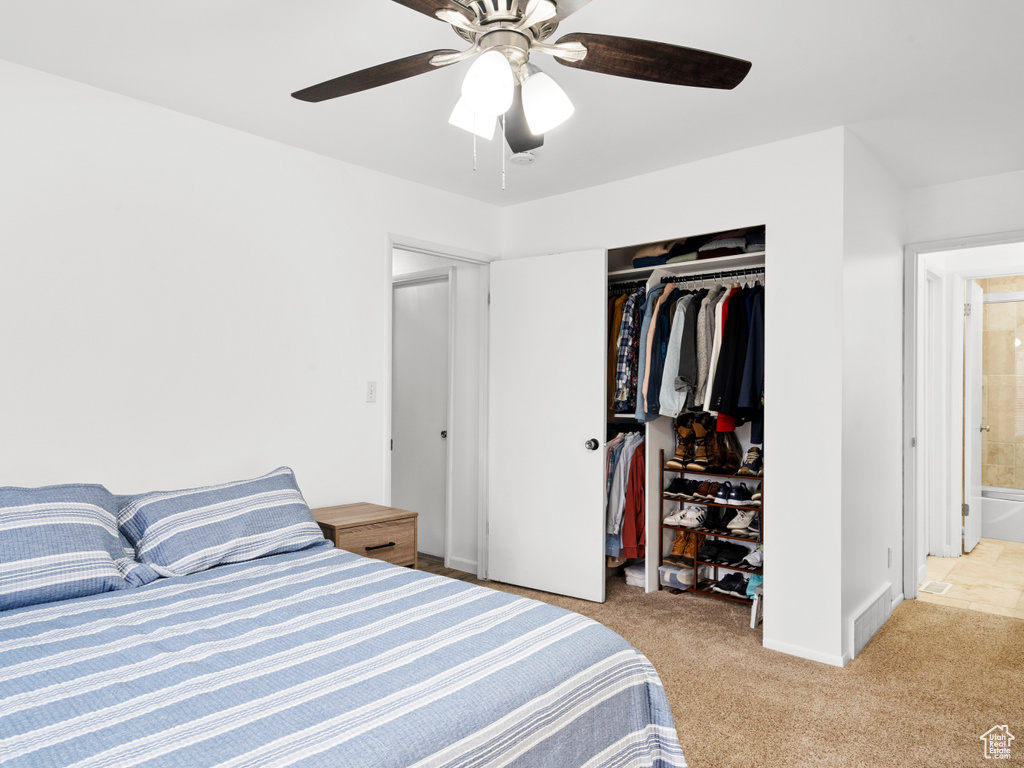 Bedroom featuring light carpet, a closet, and ceiling fan
