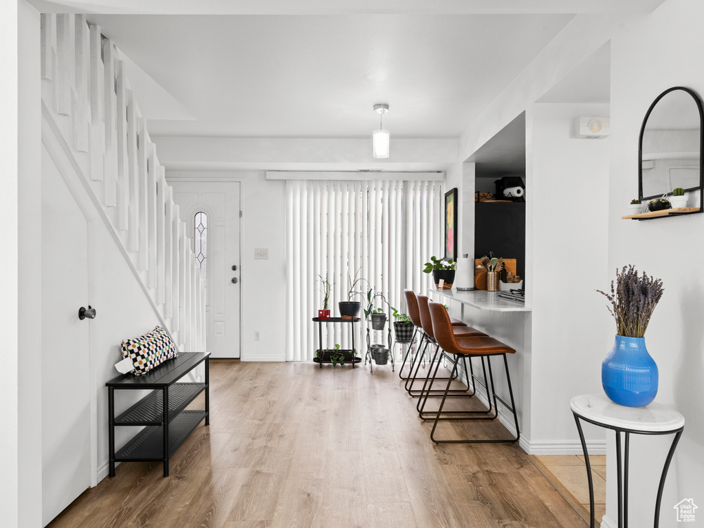 Entryway featuring wood finished floors and stairway