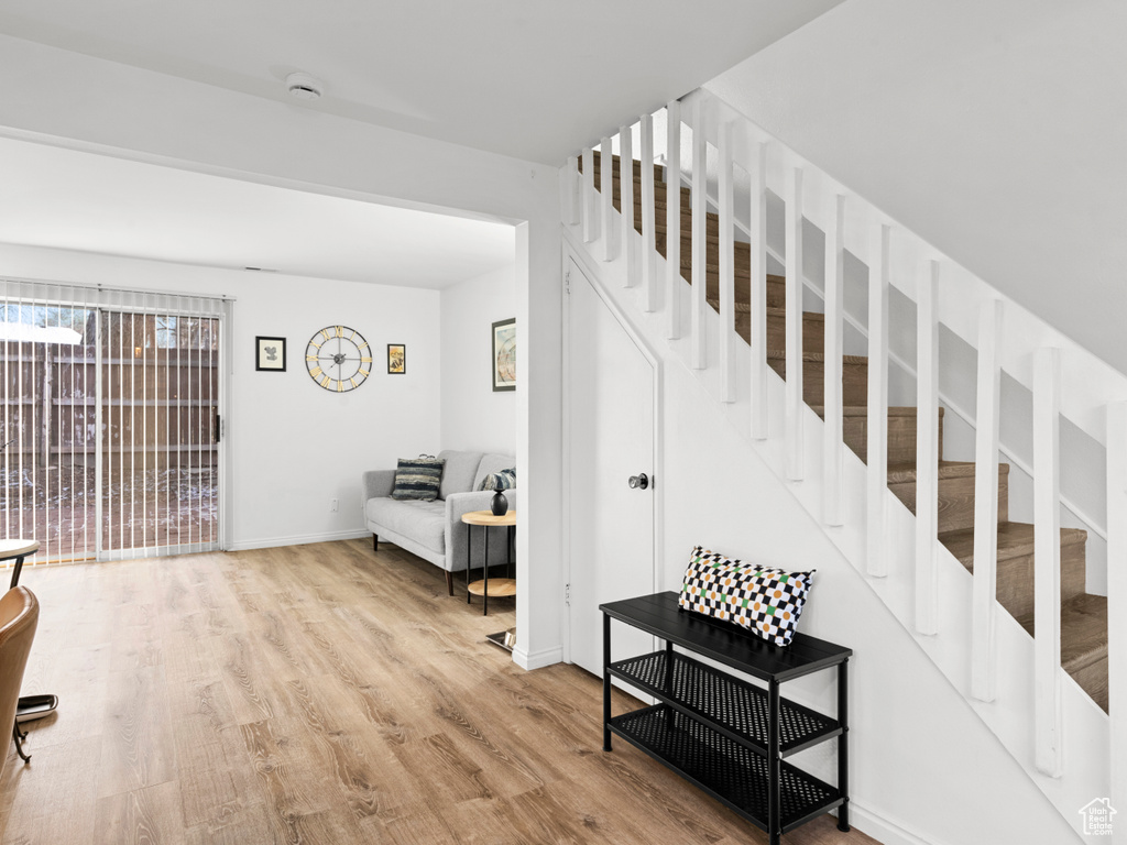Staircase with wood finished floors and baseboards