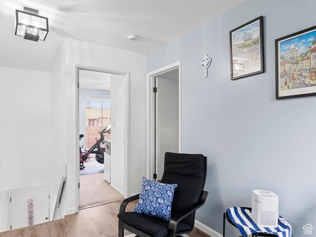 Sitting room with wood finished floors and baseboards