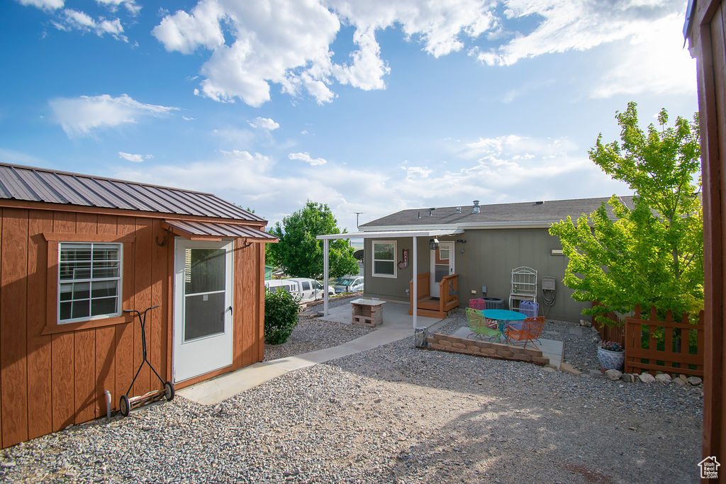 View of yard with a patio area and an outbuilding