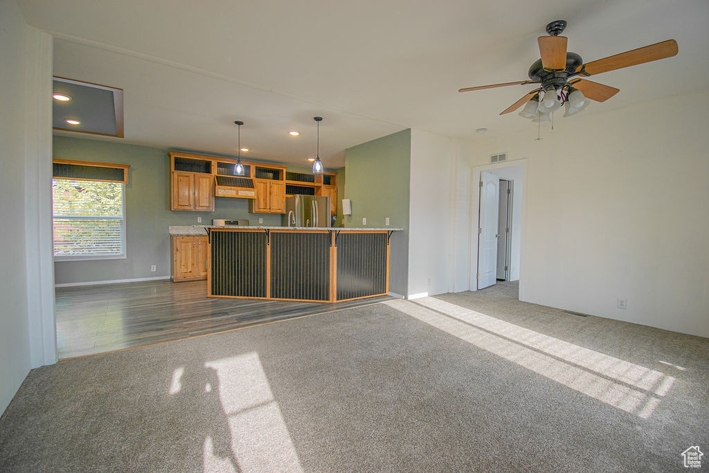 Unfurnished living room with dark carpet, recessed lighting, a ceiling fan, and dark wood-type flooring