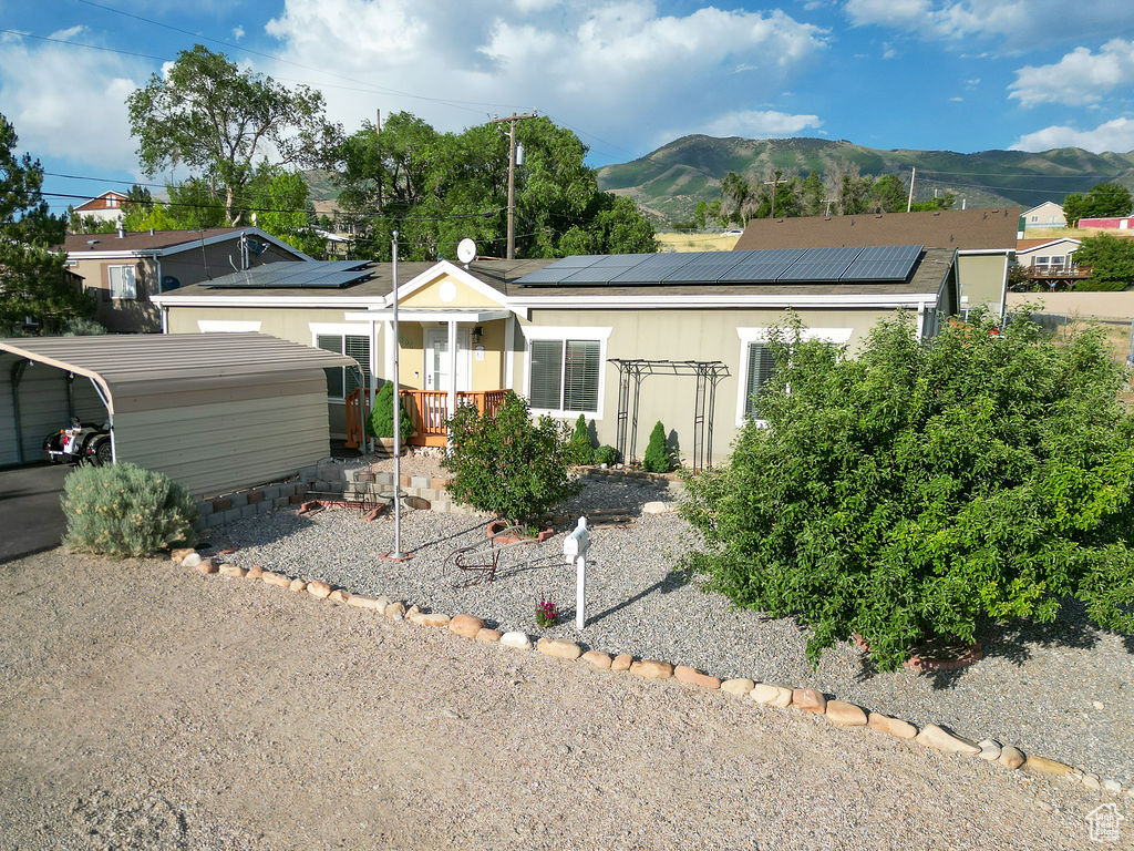 Ranch-style home with a mountain view and solar panels