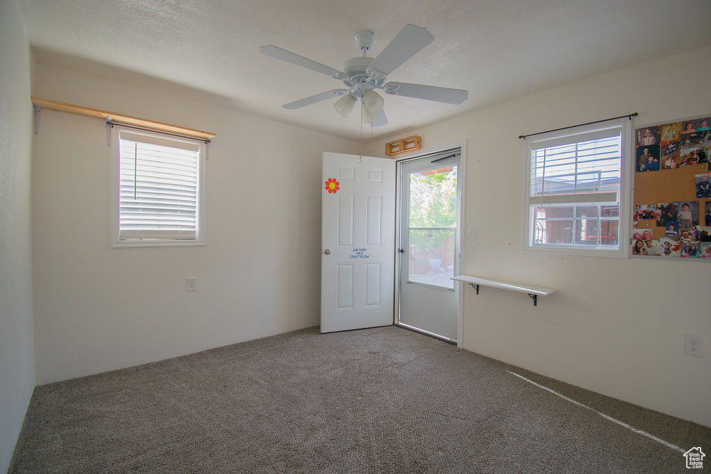 Spare room with carpet floors and ceiling fan