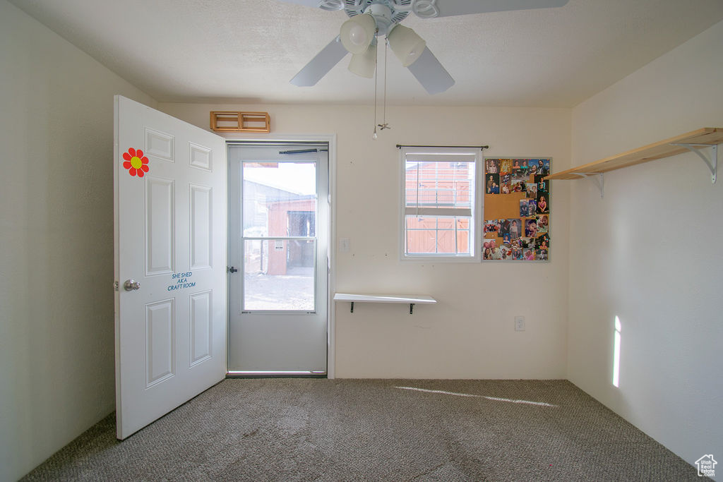 Unfurnished bedroom with carpet and a ceiling fan
